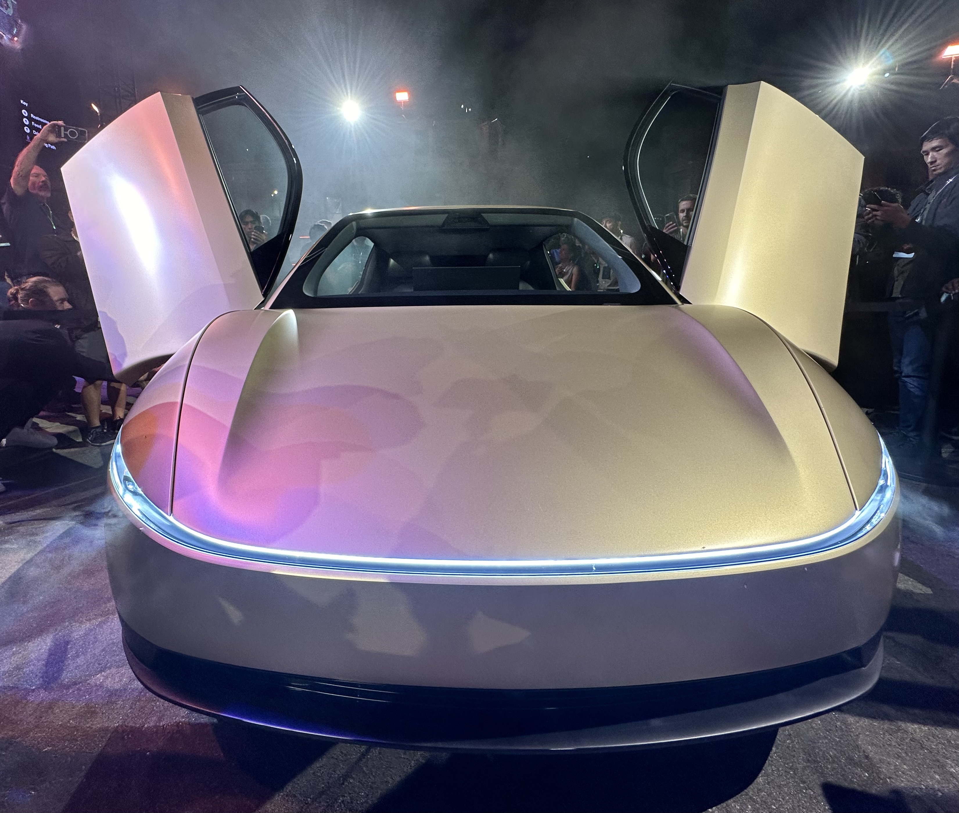 Front view of a gold Cybercab with its doors open at its unveiling
